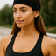 Woman wearing a black headband and tank top outdoors