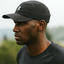 Athlete wearing black Grand Performance Running Cap while running outdoors