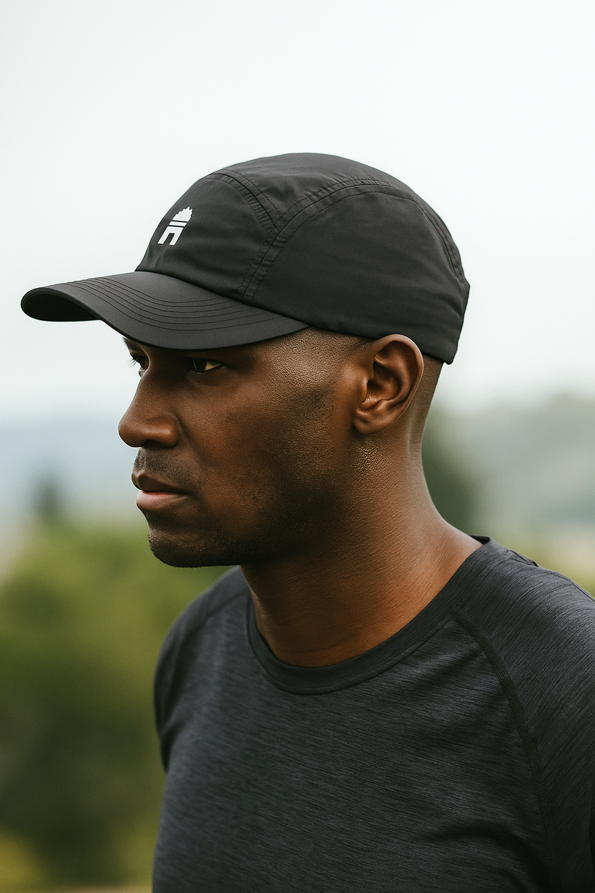 Athlete wearing black Grand Performance Running Cap while running outdoors